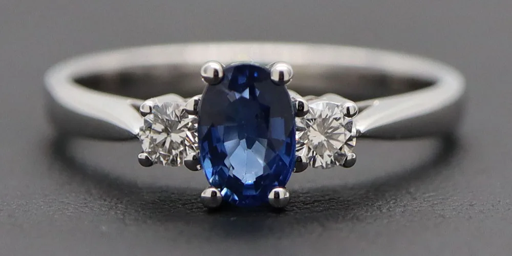 A picture of a ring taken on a leatherette background