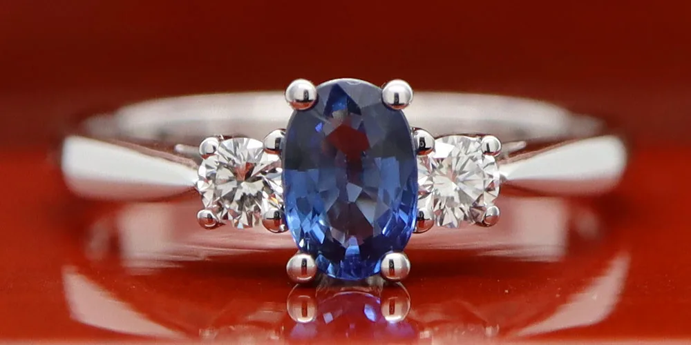 A picture of a ring taken on a shiny wooden background