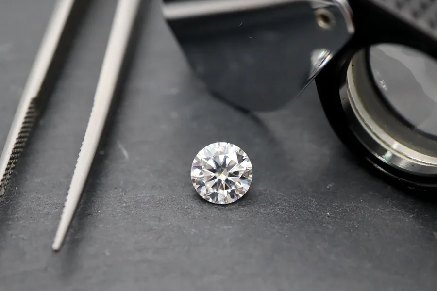 A Diamond with a loupe and pair of tweezers