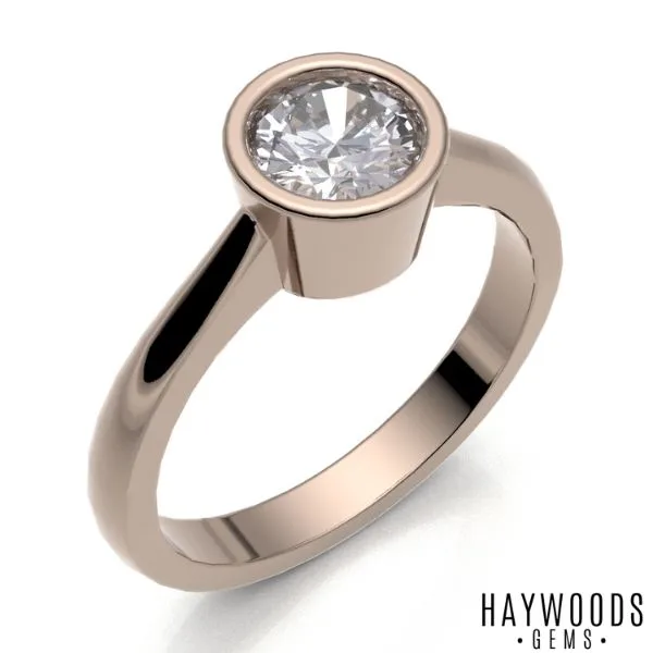 A bezel set solitaire ring